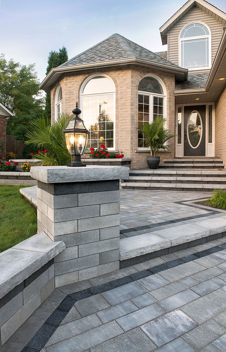 Stone pillar and retaining wall at an elegant home entry
